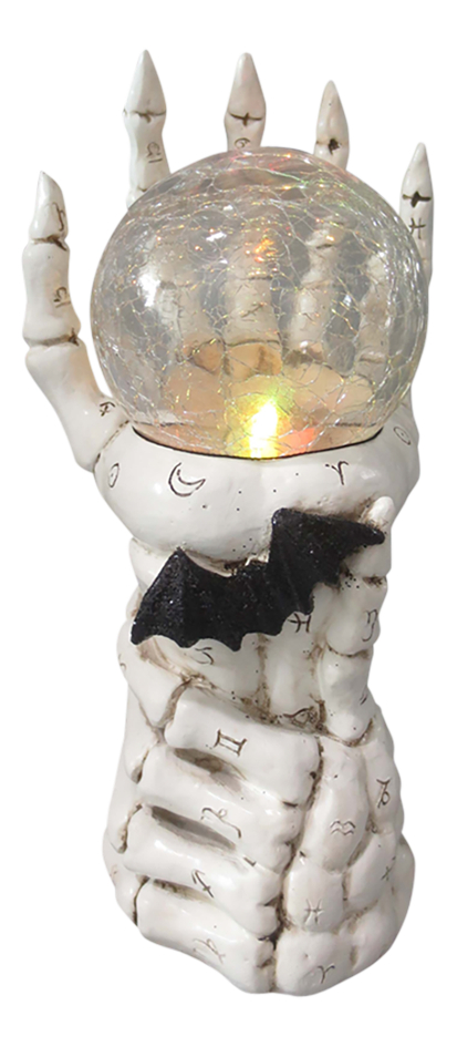 Figuur skelettenhand met lichtgevende bal